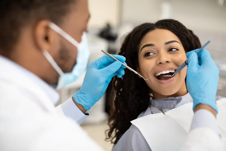 Patient having a check-up with a dentist in a modern clinic