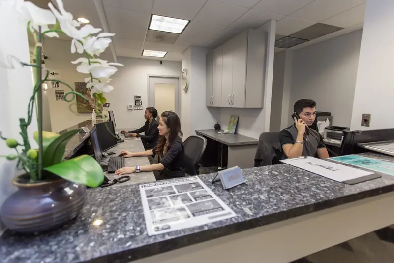 The DC Dental Spa front desk team assisting patients