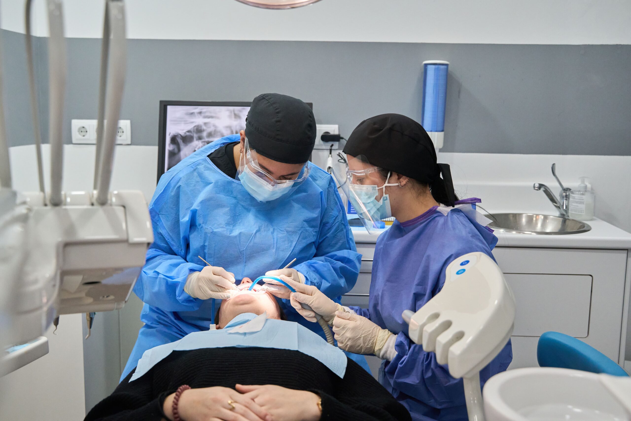 Dentist and assistant performing dental procedure on patient