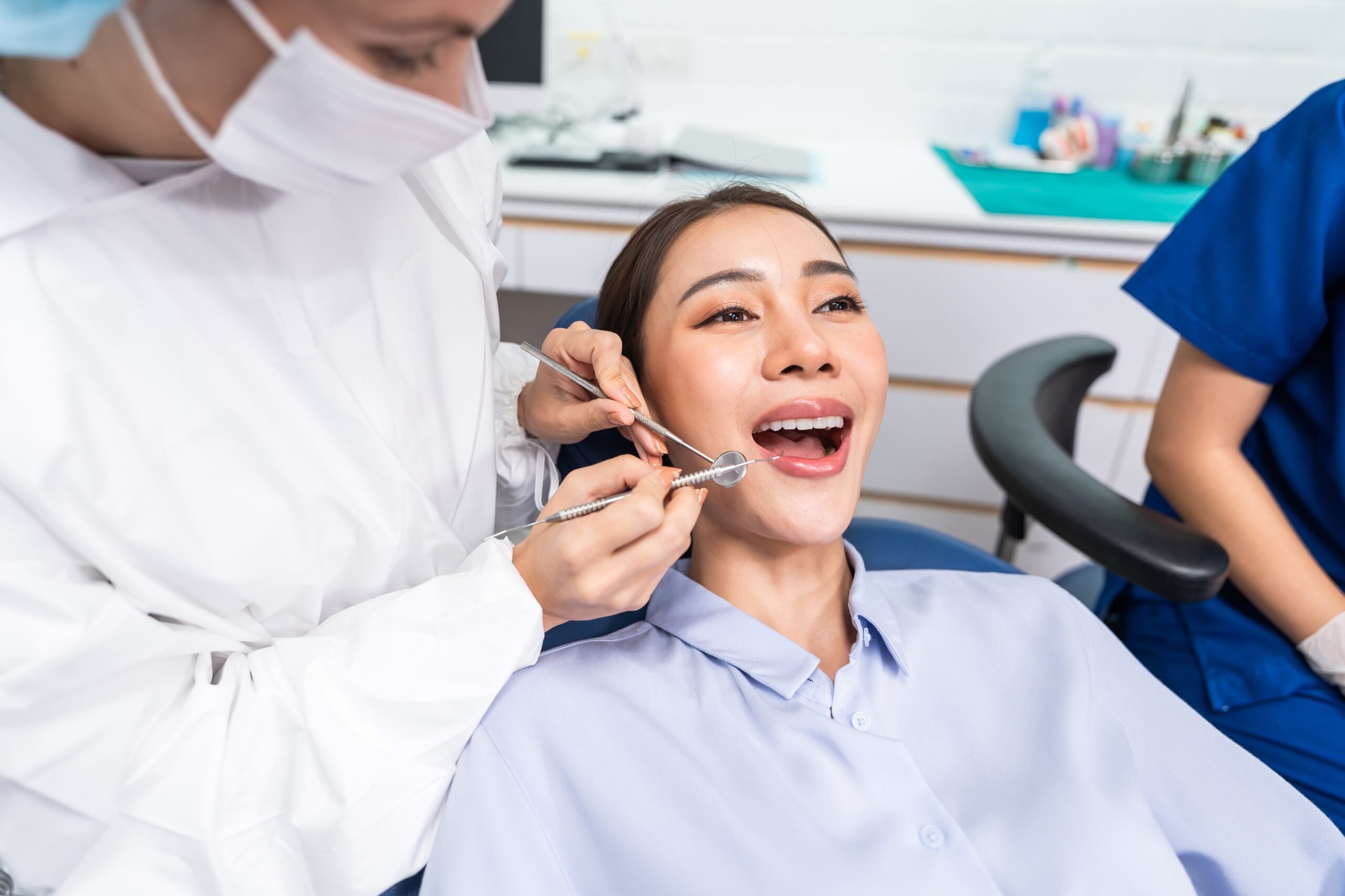 Caucasian dentist examine tooth for young girl at dental health clinic.